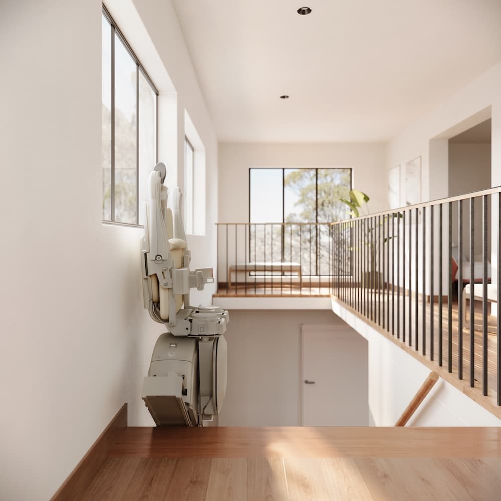 A stairlift fitted at the top of a staircase in an Irish home, installed with grant support.